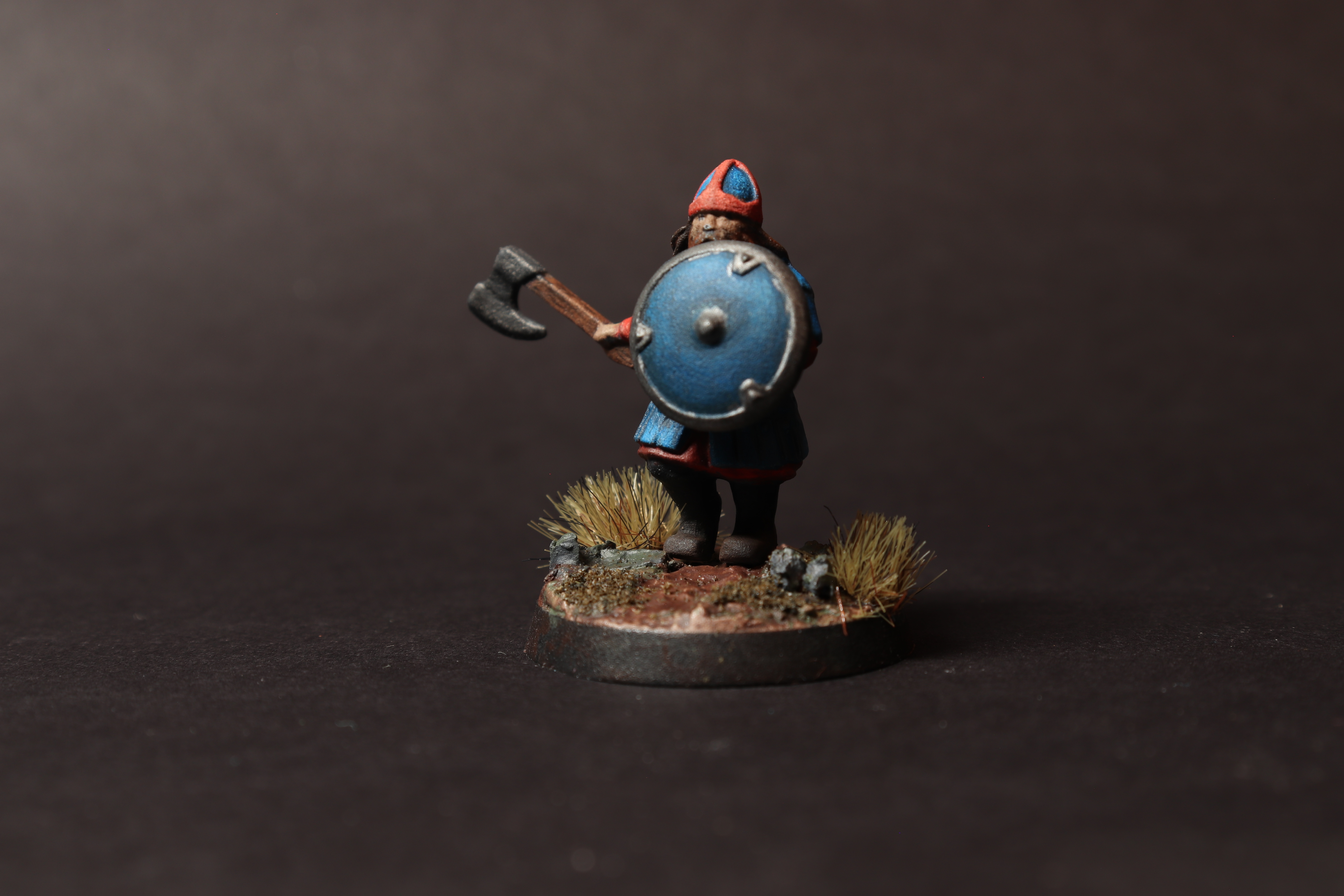 Left angle view of the dwarf warrior miniature with the shield forward and axe visible.